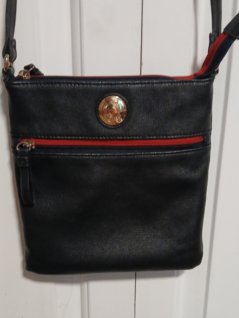 Black Crossbody Bag with Red Trim and Gold Medallion